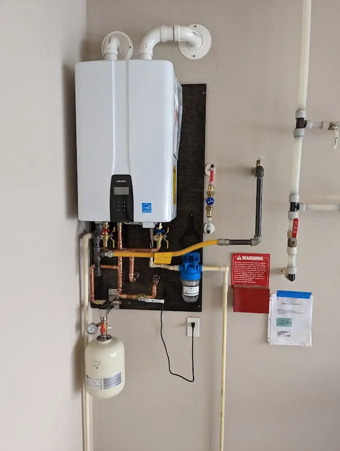 Professional plumber installing copper piping in a Hesston home